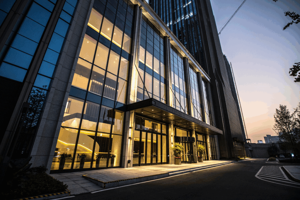 The front of a commercial building with sleek glass windows.