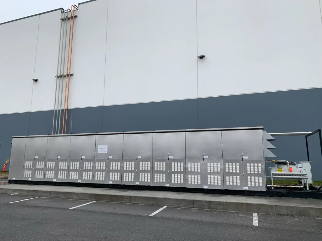 Industrial refrigeration and HVAC equipment installed outside a commercial facility.