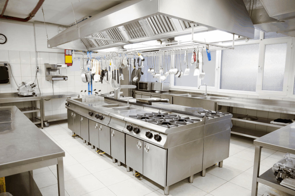Wide shot of a clean, industrial kitchen and stainless steel appliances