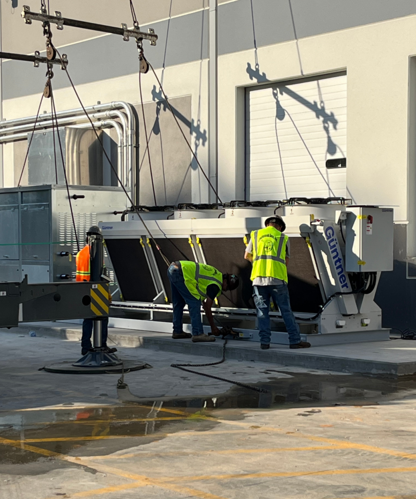 3 CoolSys technicians outside in PPE working on CO2 equipment