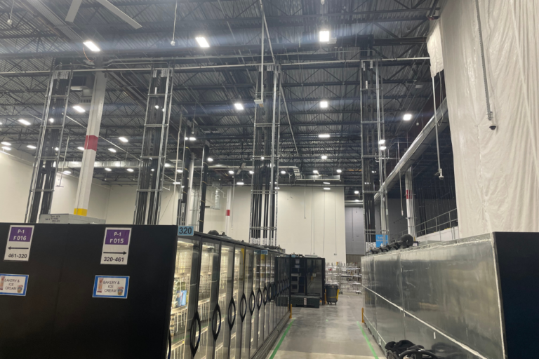 Warehouse with row of refrigeration, piping, and extended lift