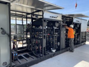 CoolSys technician outside in PPE working on CO2 equipment