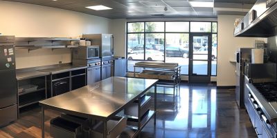 Commercial kitchen filled with stainless steel countertops and appliances