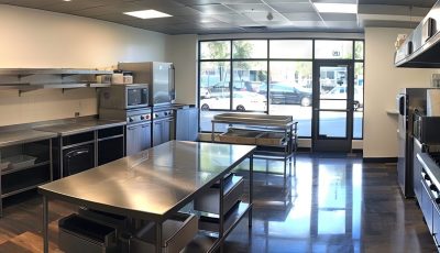 Commercial kitchen filled with stainless steel countertops and appliances
