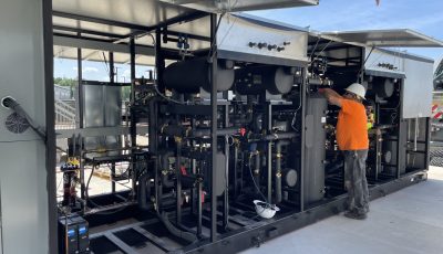 CoolSys technician outside in PPE working on CO2 equipment